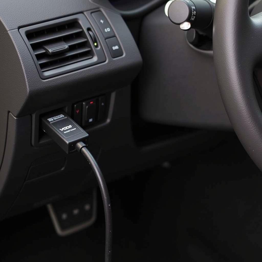 VCDS 12.12 HEX CAN USB Cable connected to a car's OBD-II port