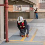 A worker performs a concrete scan using ground penetrating radar