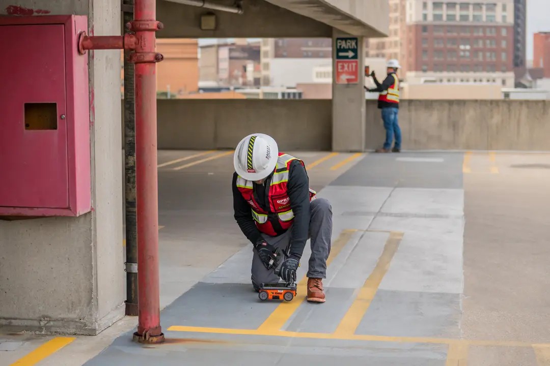 A worker performs a concrete scan using ground penetrating radar