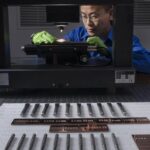 NIST researcher Alan Zheng uses a 3D disc scanning confocal microscope to examine a chisel toolmark