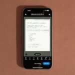 A person using an iPhone to scan a document with Adobe Scan app, showcasing its document scanning capabilities.
