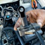 Automotive technician using diagnostic tools to check a faulty MAP sensor, highlighting the process of MAP sensor diagnosis