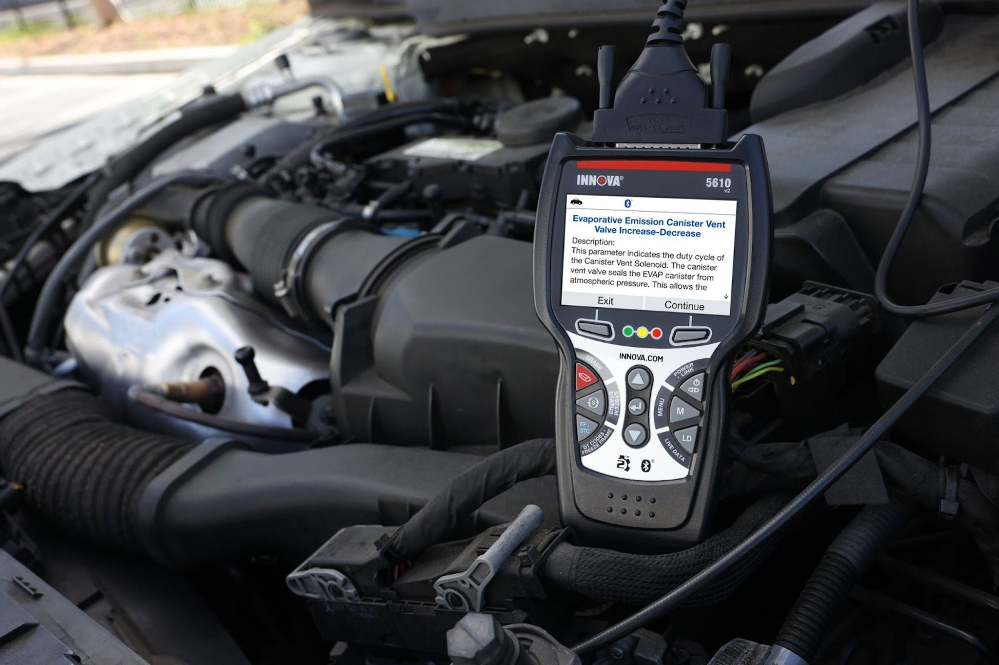 Close-up view of an OBD2 scanner diagnosing a faulty MAP sensor, emphasizing the use of automotive diagnostic equipment