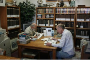 Researchers working with vintage car documents at the Horseless Carriage Foundation Inc. Automotive Research Library